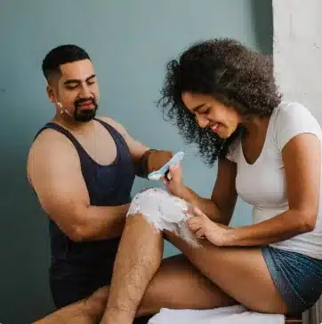 Husband is visibly nauseated and shocked as he instructs his wife on how to shave her manlegs.  The unkempt forest can breed harmful bacteria, bankrupt a man's authority and fill the house with unbridled estrogen sweats.  